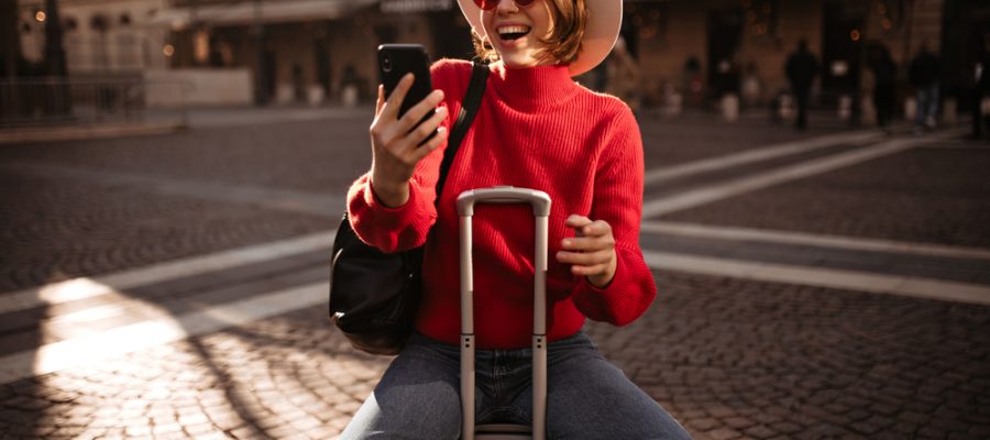 Happy,Short-haired,Woman,In,Beige,Hat,,Red,Sweater,And,Jeans