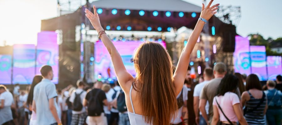 Back,View,Of,Girl,With,Raised,Arms,,Enjoying,Live,Music